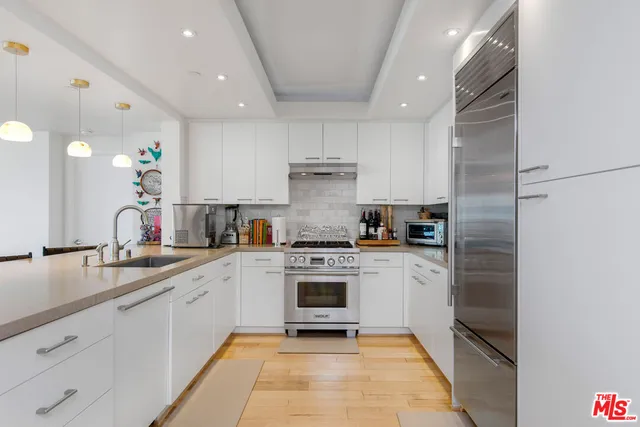 a kitchen with a sink stainless steel appliances and cabinets