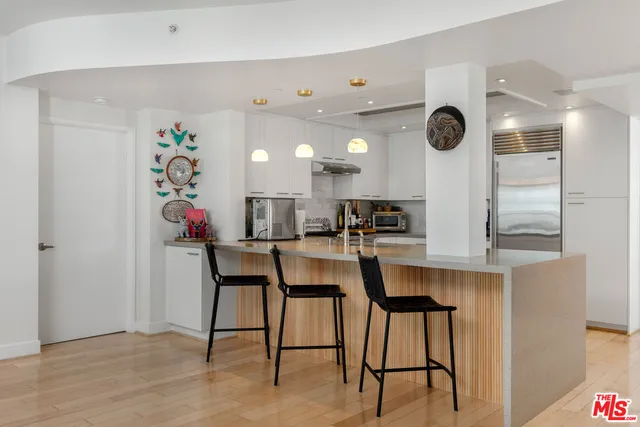 a view of kitchen with stainless steel appliances kitchen island microwave and cabinets