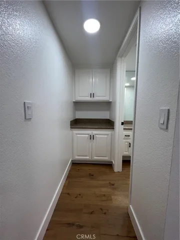 a kitchen with white cabinets and white appliances