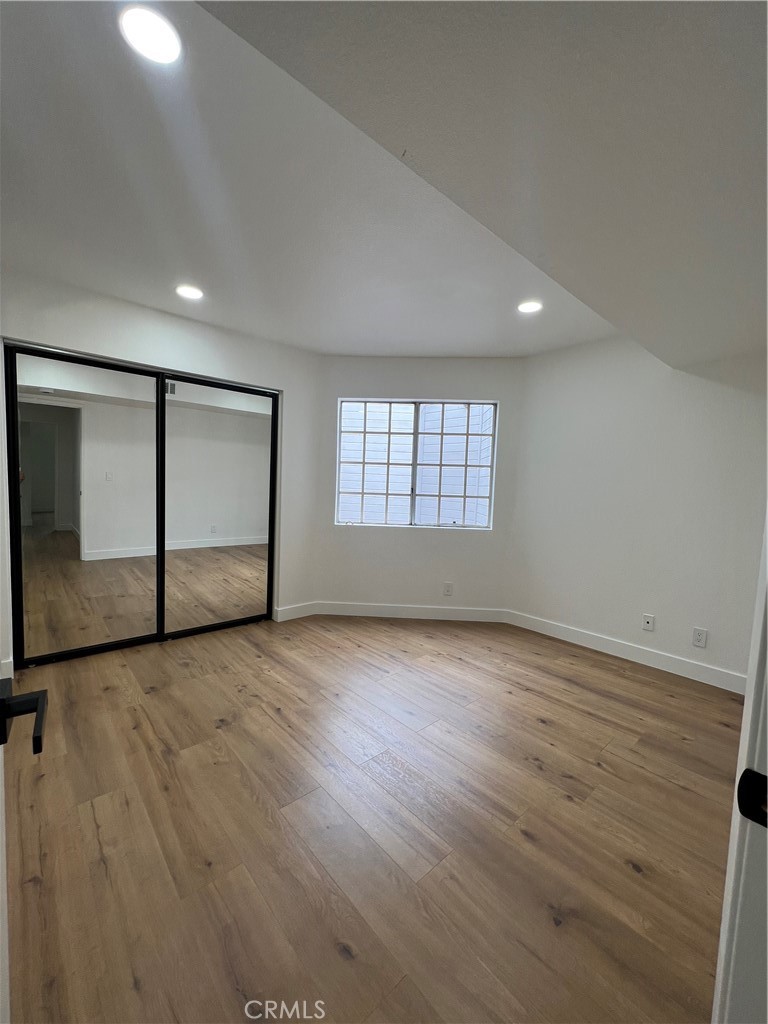 1731 East 68th Street Long Beach, CA 90805 - Photo 17 of 27 an empty room with wooden floor and windows