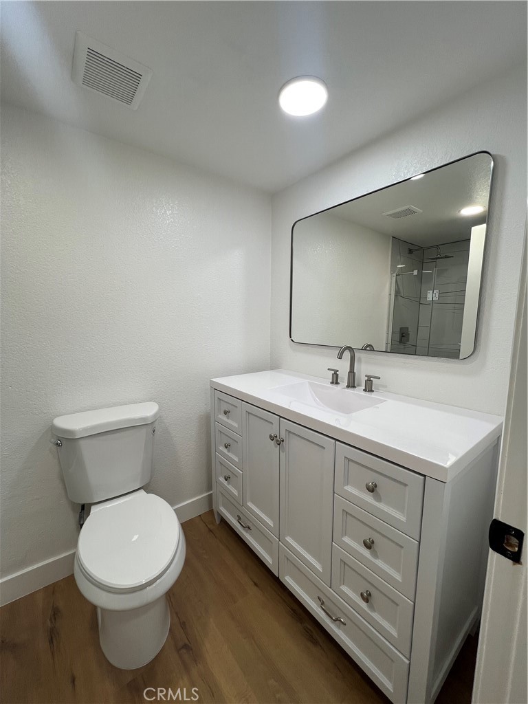 1731 East 68th Street Long Beach, CA 90805 - Photo 21 of 27 a bathroom with a toilet sink and mirror