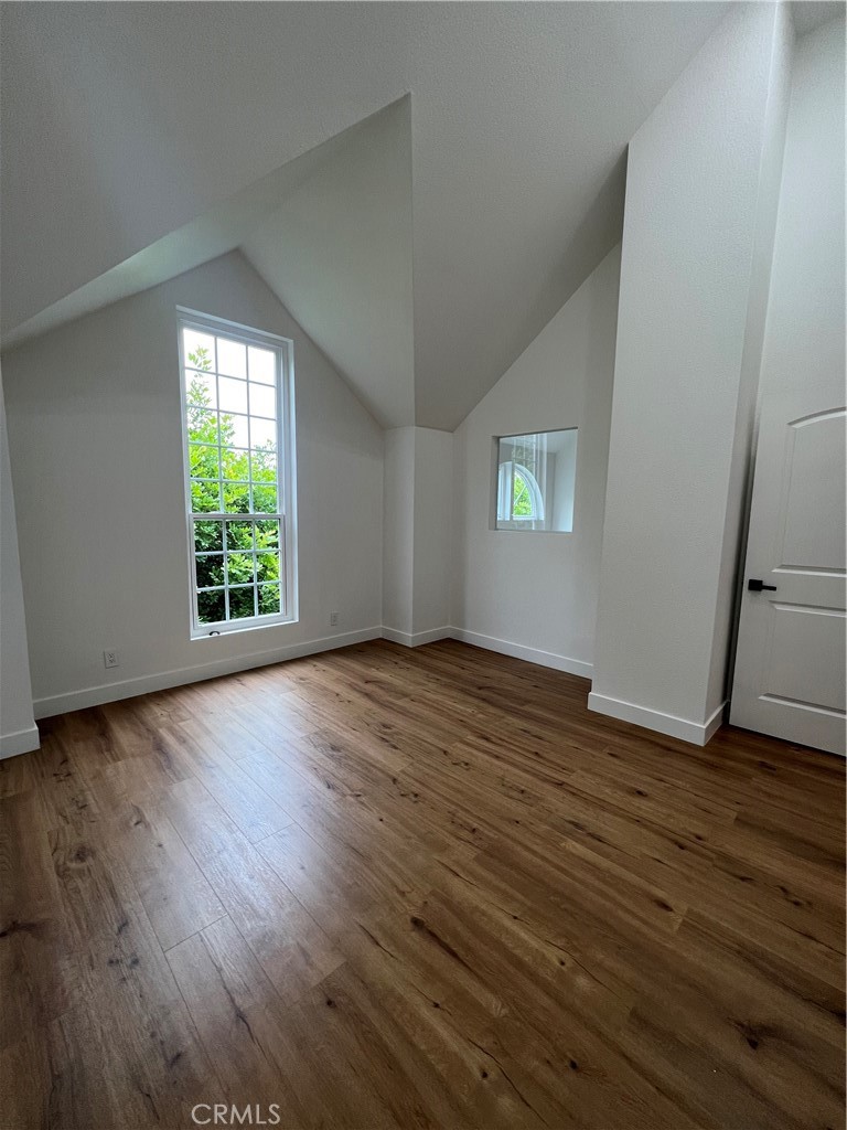 1731 East 68th Street Long Beach, CA 90805 - Photo 24 of 27 an empty room with wooden floor and windows