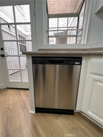 a view of a kitchen with wooden floor and a large window