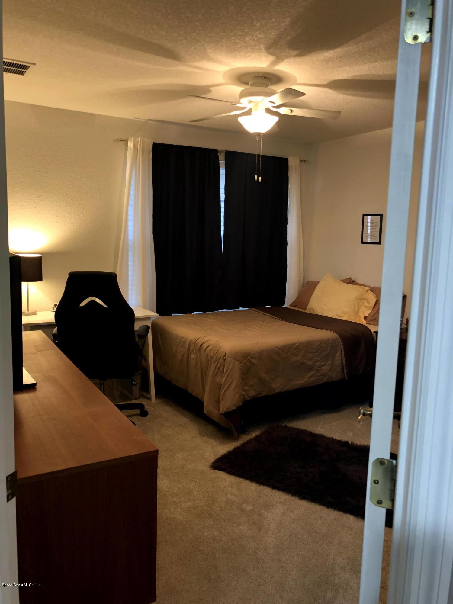 100 Turpial Way, Unit 107 Melbourne, FL 32901 - Photo 16 of 49 a bedroom with a bed and a closet