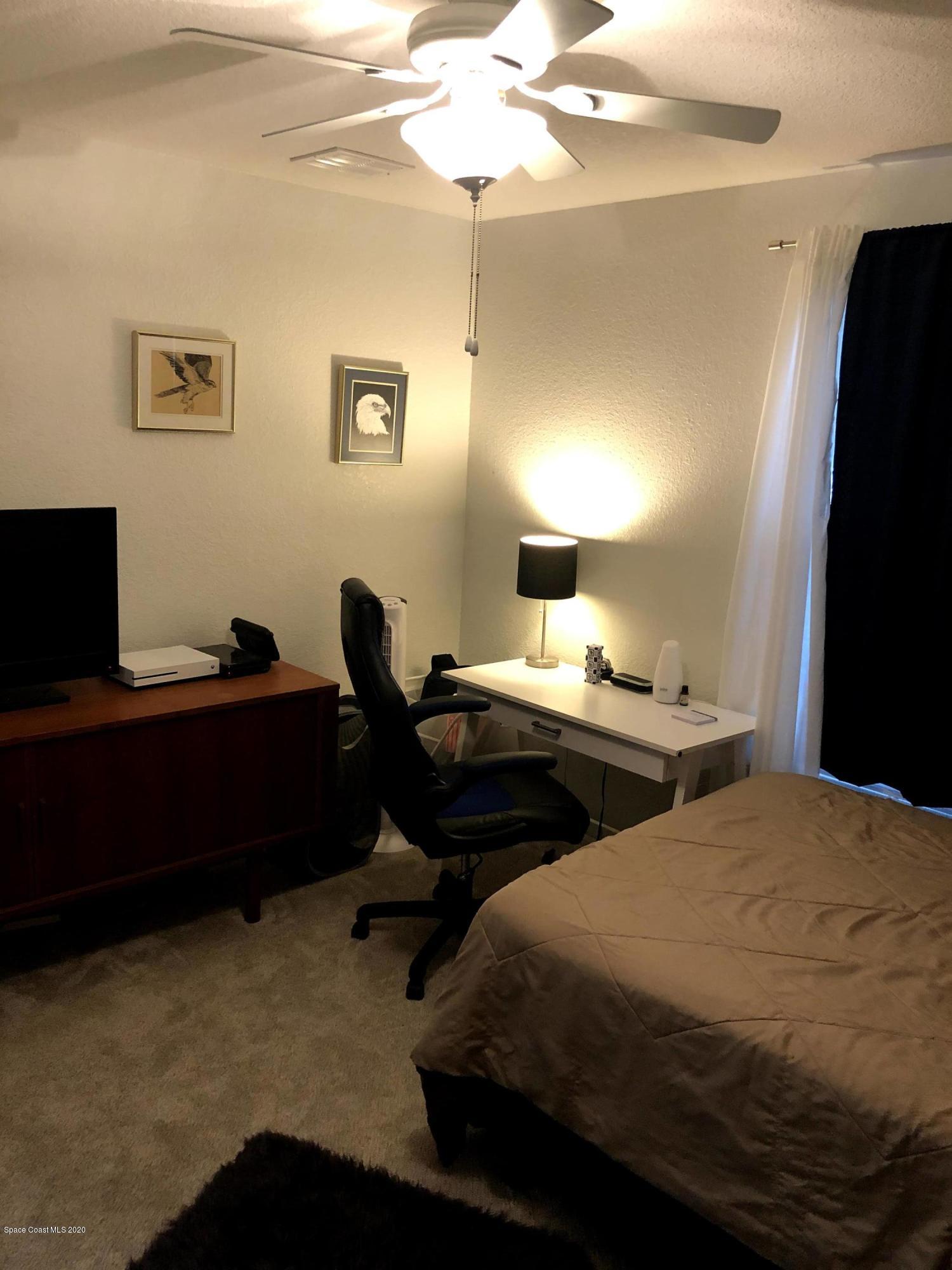 100 Turpial Way, Unit 107 Melbourne, FL 32901 - Photo 17 of 49 a bedroom with bed and window