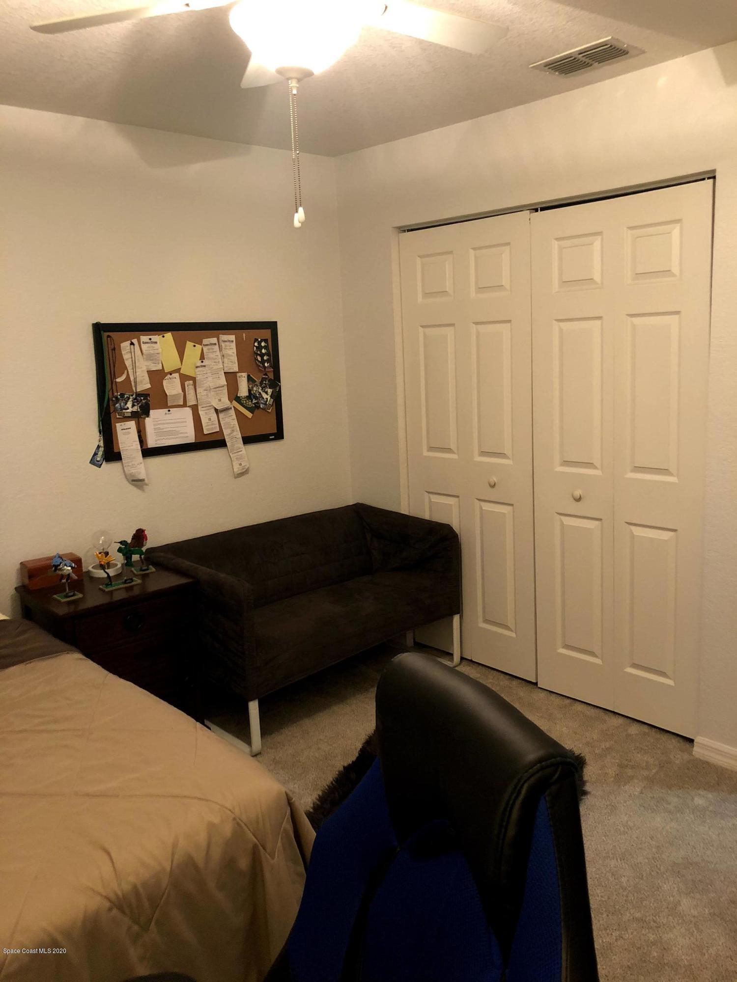 100 Turpial Way, Unit 107 Melbourne, FL 32901 - Photo 19 of 49 a bedroom with a bed and a window