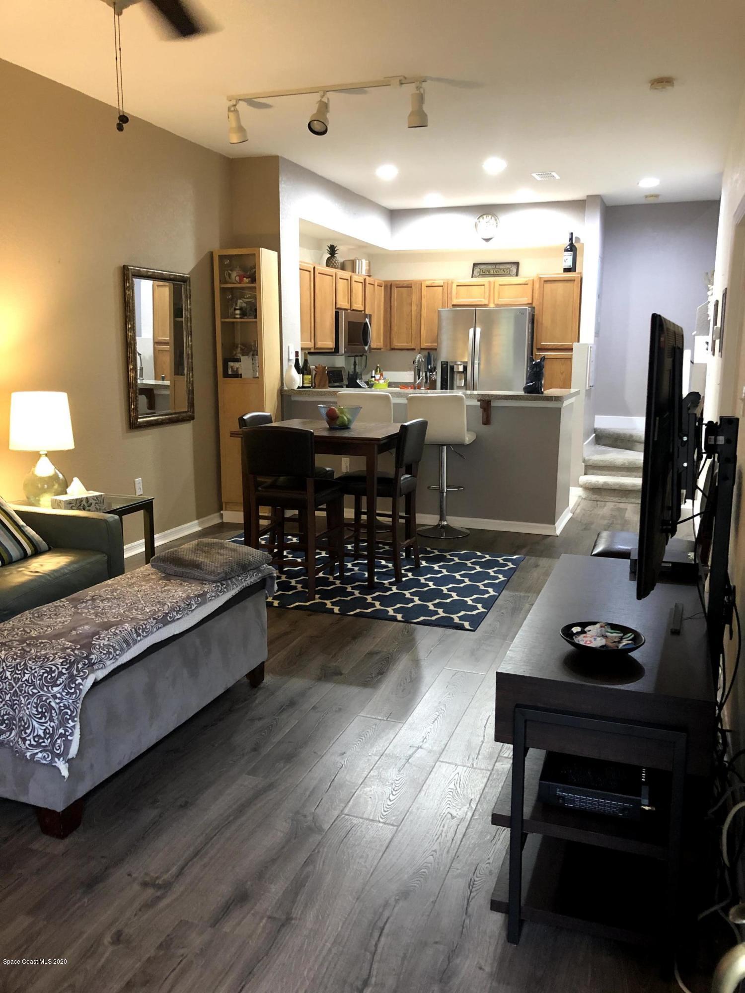 100 Turpial Way, Unit 107 Melbourne, FL 32901 - Photo 3 of 49 a living room with furniture and wooden floor