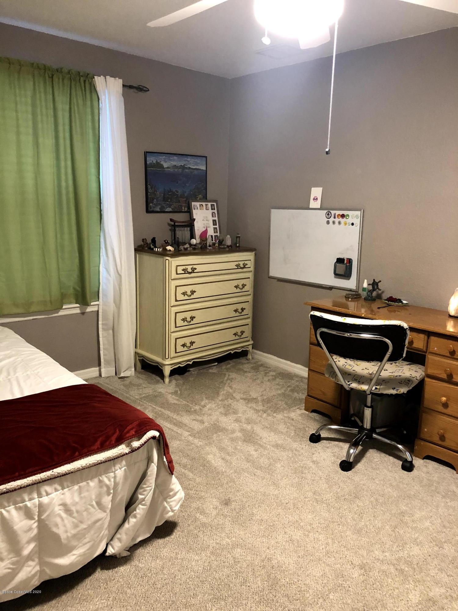 100 Turpial Way, Unit 107 Melbourne, FL 32901 - Photo 24 of 49 a bedroom with a workspace