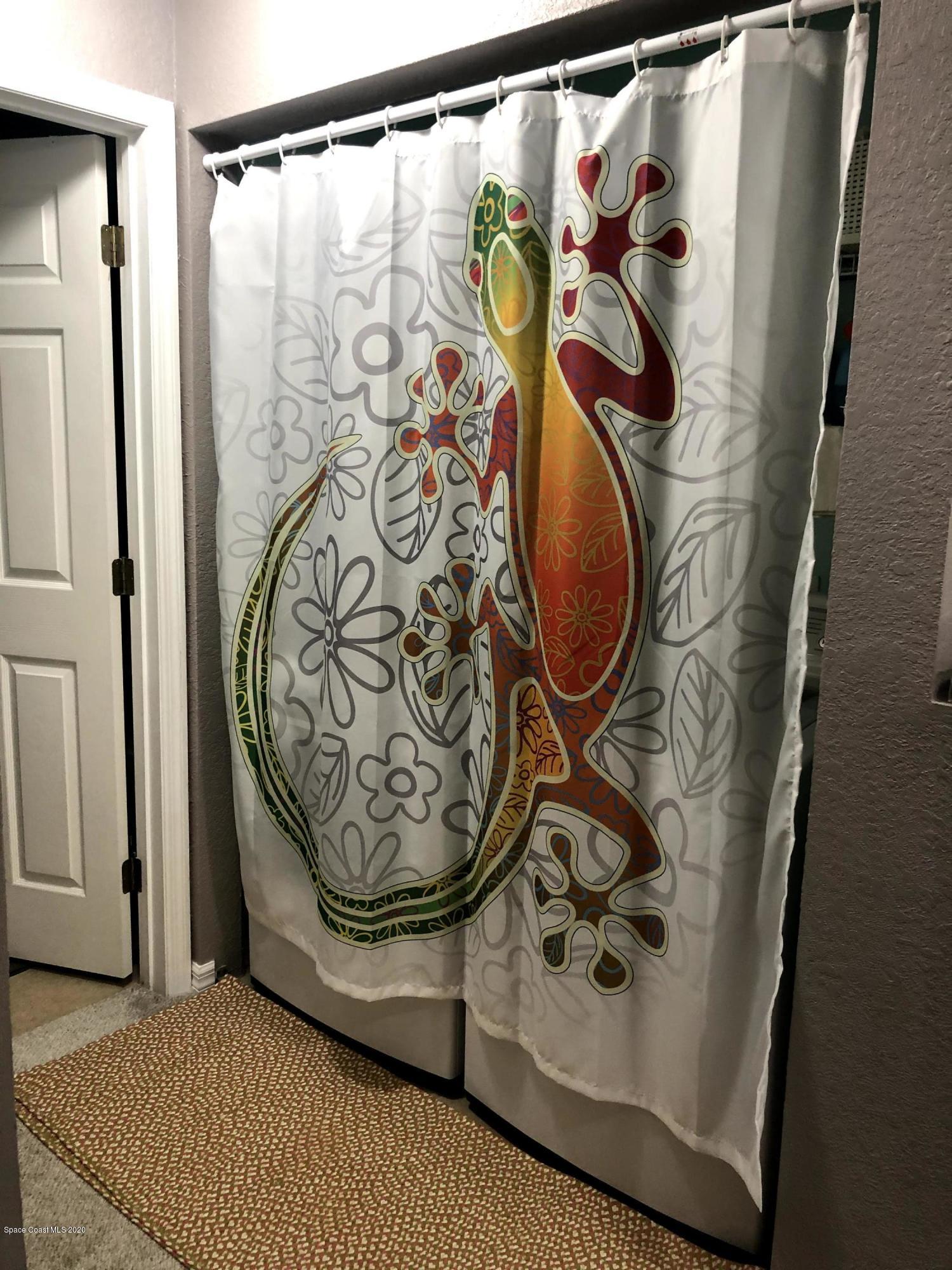 100 Turpial Way, Unit 107 Melbourne, FL 32901 - Photo 25 of 49 a view of walk in closet with clothes and shoes