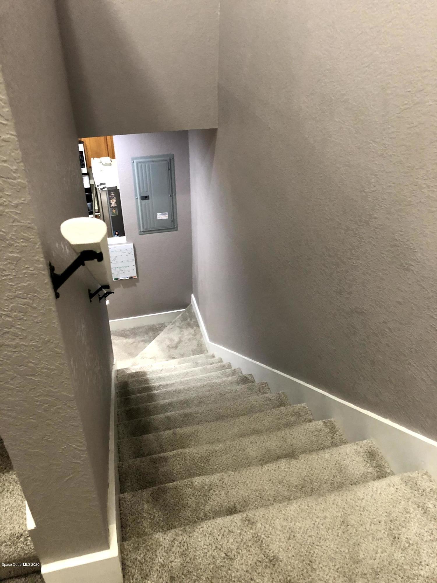 100 Turpial Way, Unit 107 Melbourne, FL 32901 - Photo 28 of 49 a bedroom with a bed and window