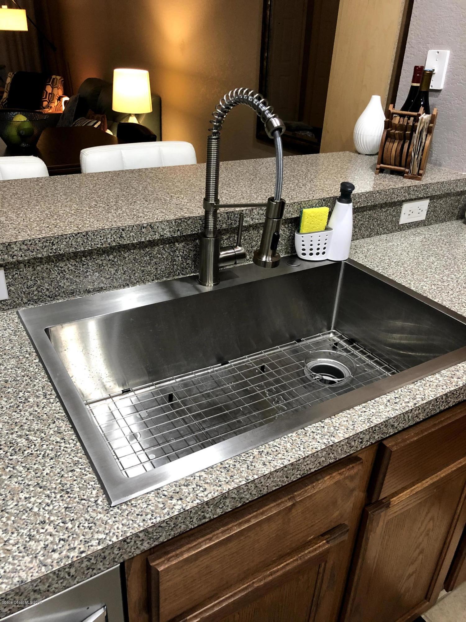 100 Turpial Way, Unit 107 Melbourne, FL 32901 - Photo 30 of 49 a stove top oven sitting inside of a kitchen counter
