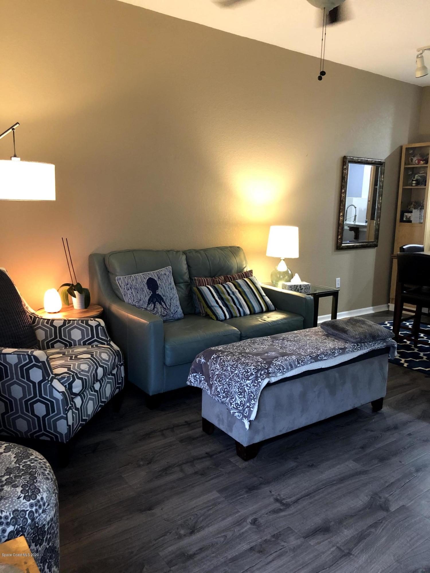 100 Turpial Way, Unit 107 Melbourne, FL 32901 - Photo 4 of 49 a living room with furniture and a couch