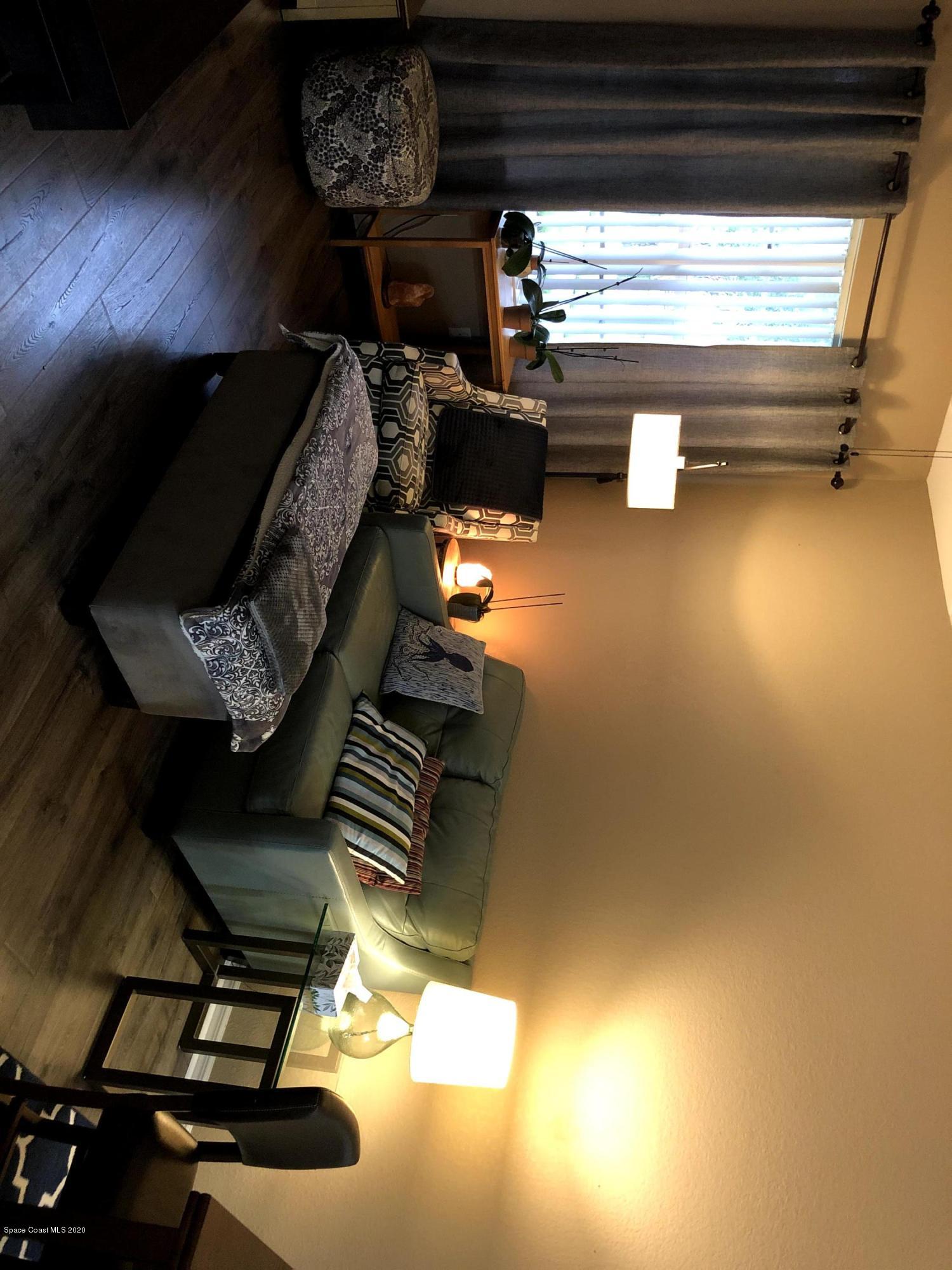 100 Turpial Way, Unit 107 Melbourne, FL 32901 - Photo 31 of 49 a hallway with a couch