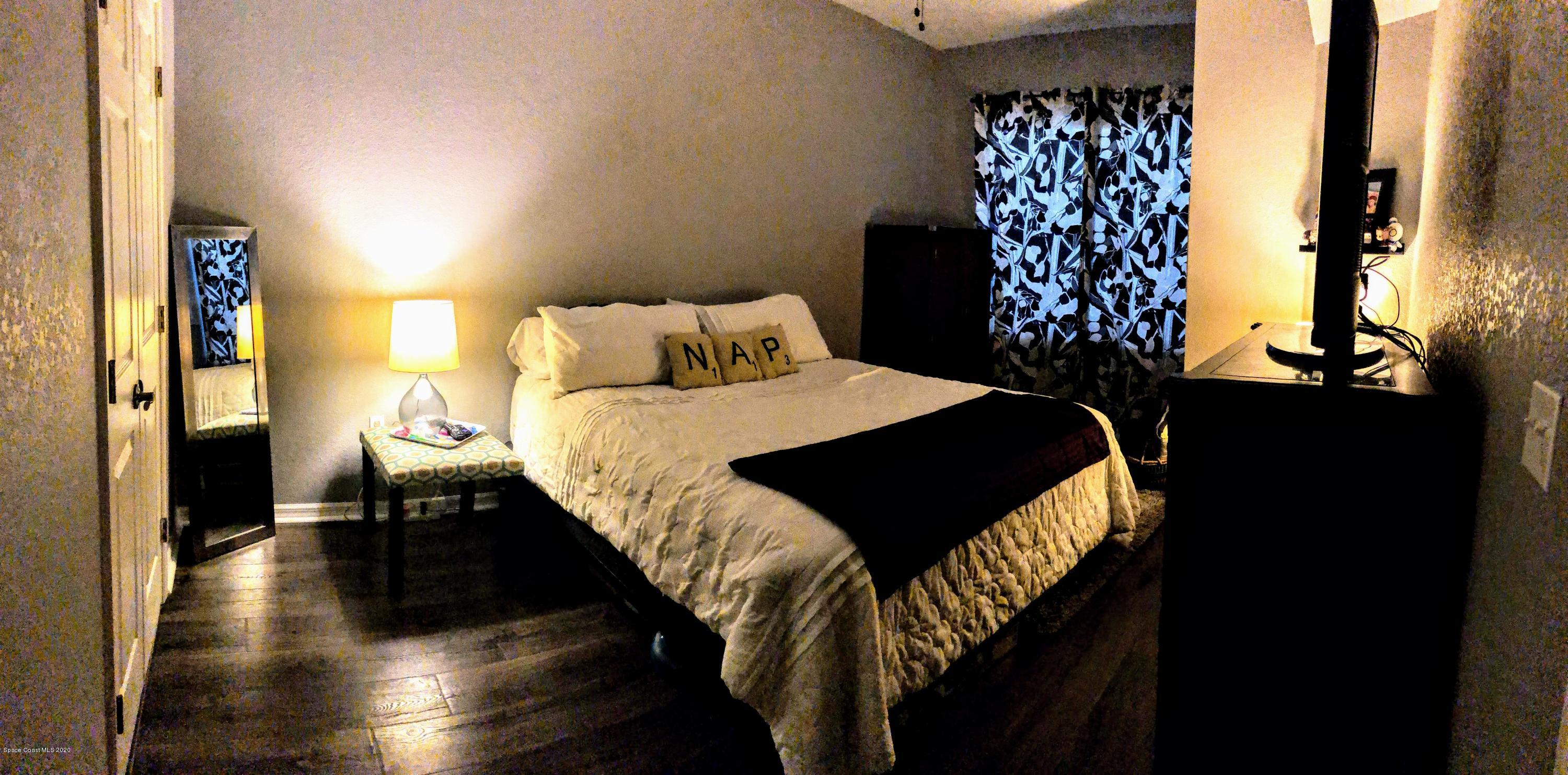 100 Turpial Way, Unit 107 Melbourne, FL 32901 - Photo 37 of 49 a bedroom with a bed and a window