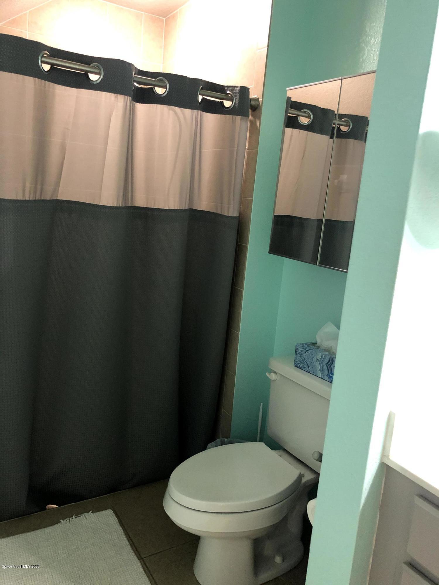 100 Turpial Way, Unit 107 Melbourne, FL 32901 - Photo 42 of 49 a bathroom with a toilet and a sink