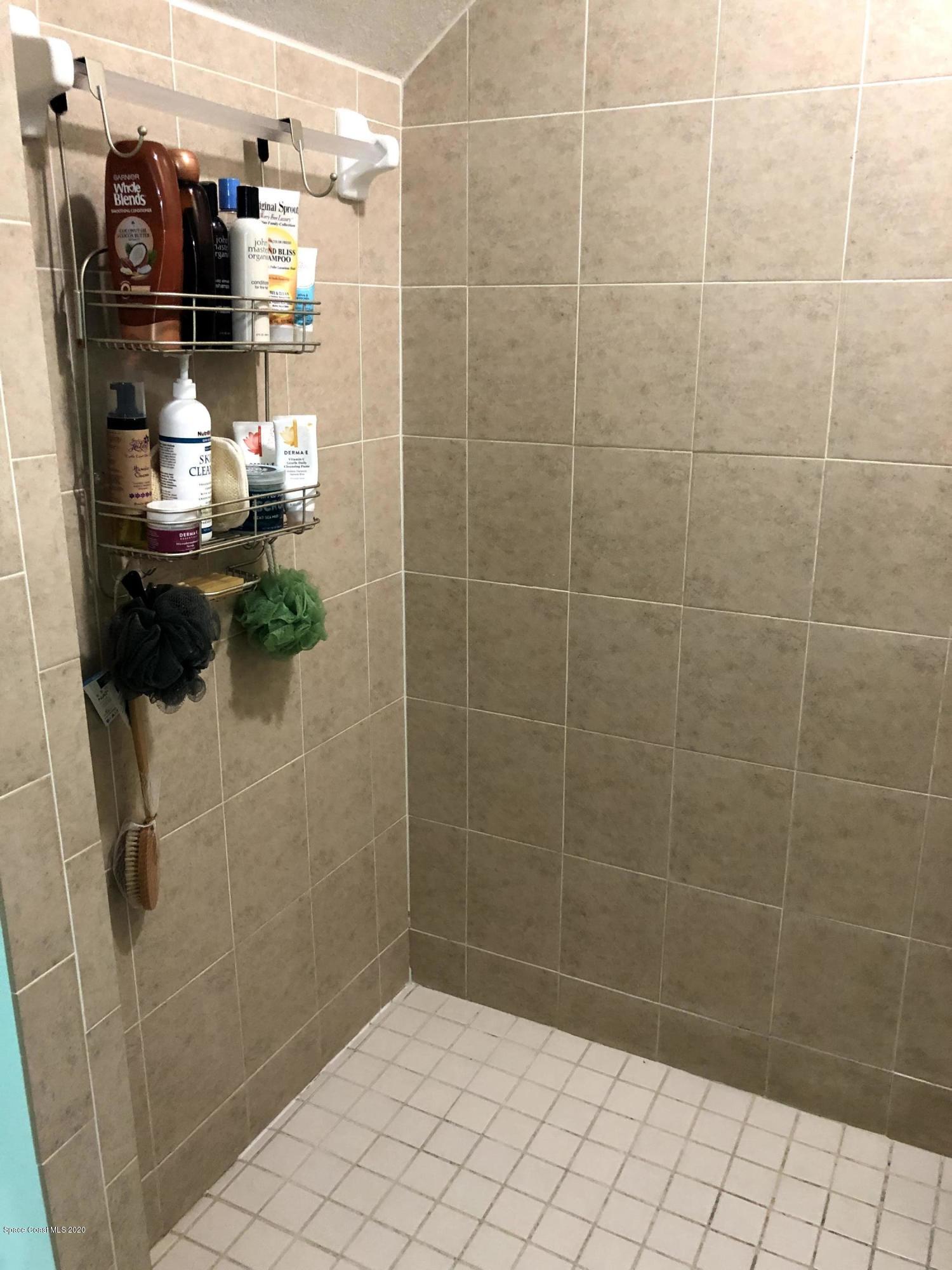 100 Turpial Way, Unit 107 Melbourne, FL 32901 - Photo 45 of 49 a bathroom with a shower