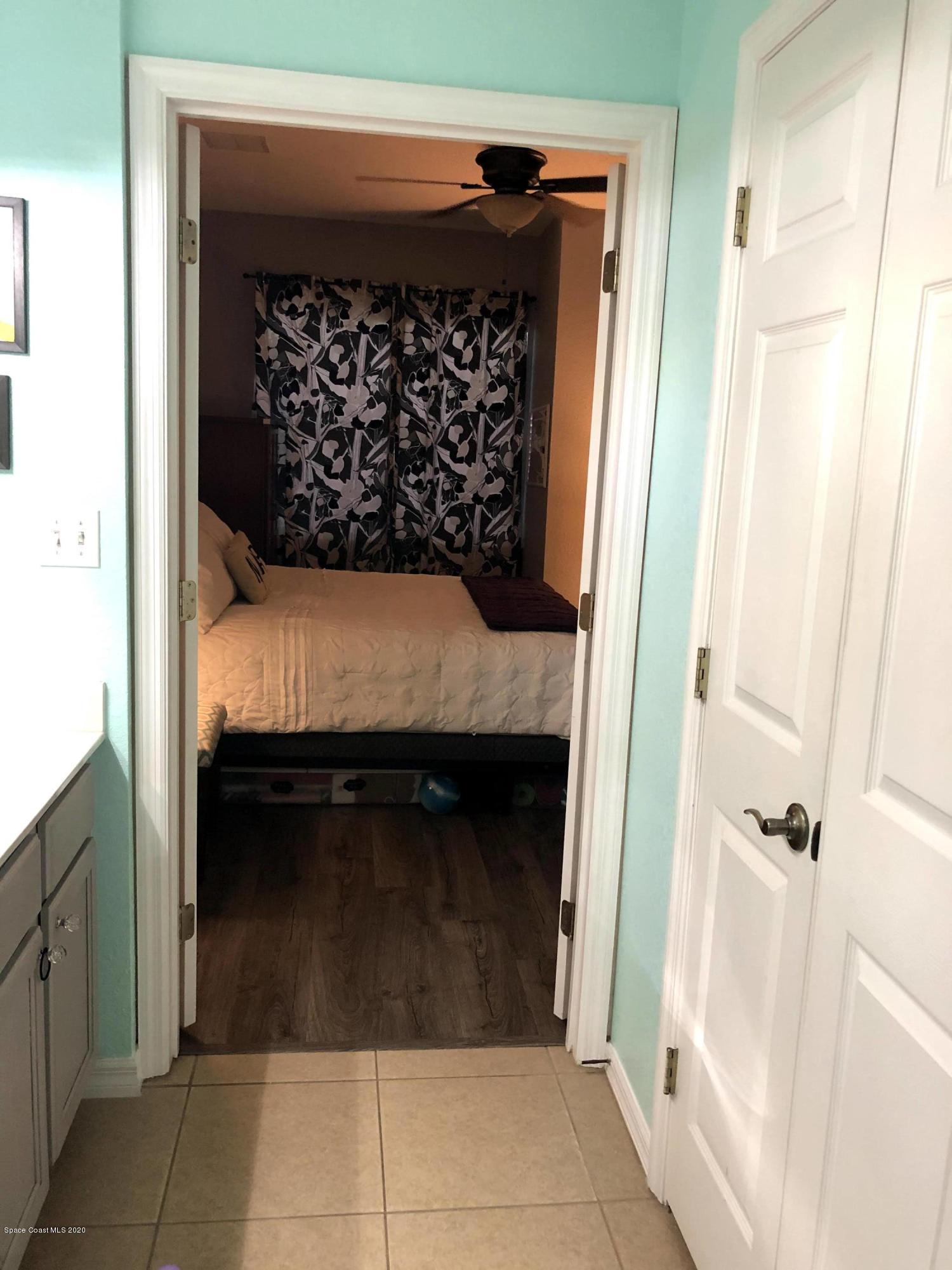 100 Turpial Way, Unit 107 Melbourne, FL 32901 - Photo 46 of 49 a bed room with a bed and a dresser