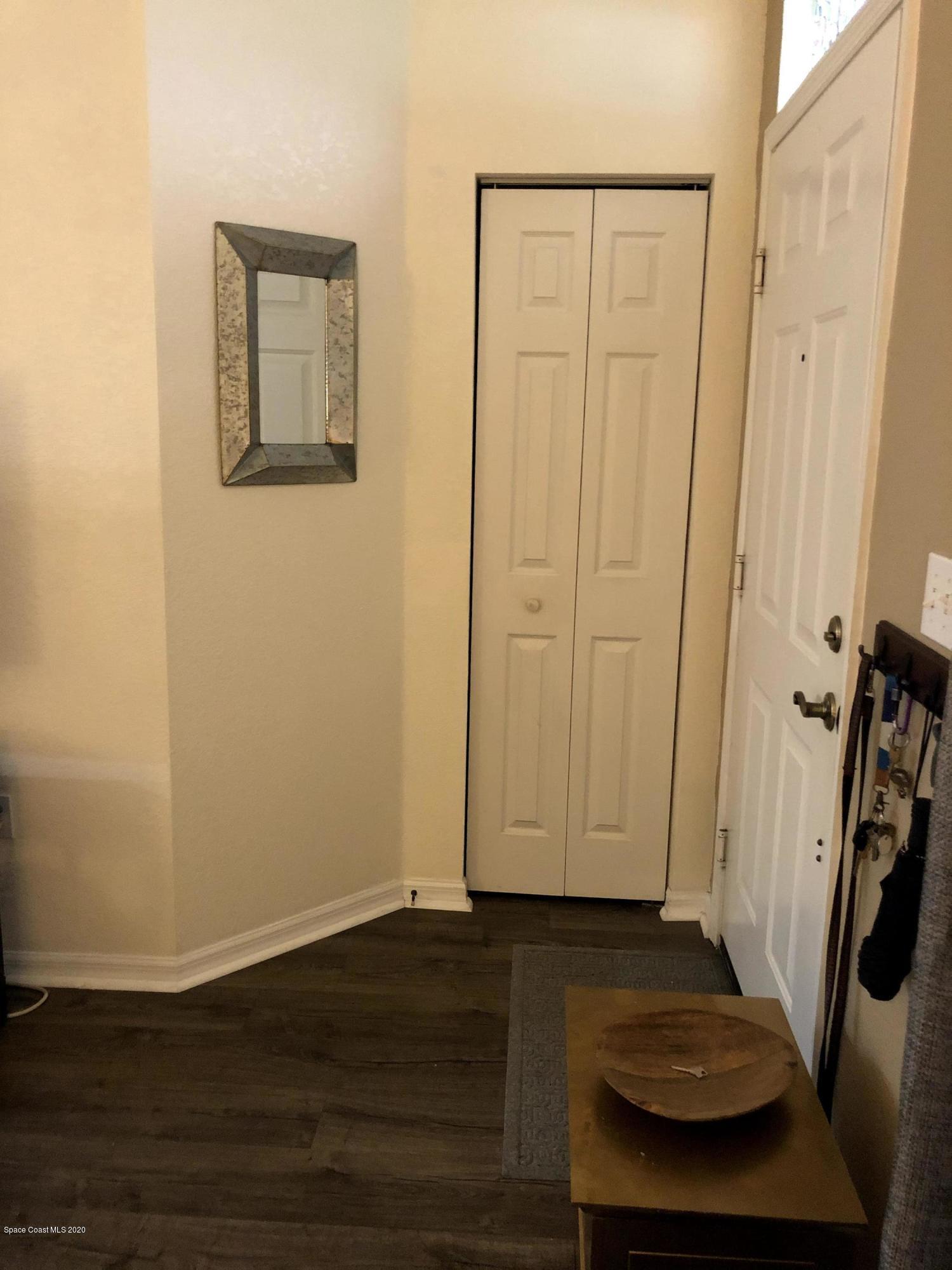 100 Turpial Way, Unit 107 Melbourne, FL 32901 - Photo 6 of 49 a view of a livingroom with hardwood floor and a ceiling fan
