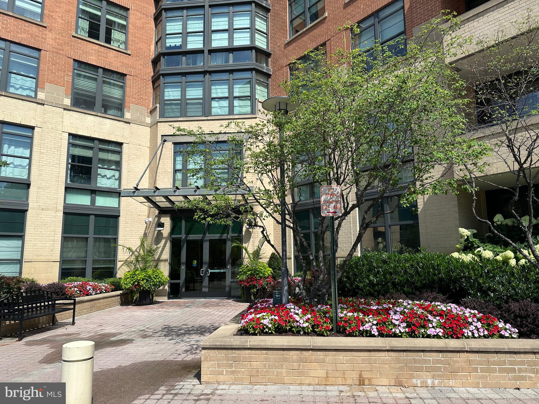 1830 Fountain Drive, Unit 607 Reston, VA 20190 - Photo 1 of 26 a front view of a building with lots of flowers around
