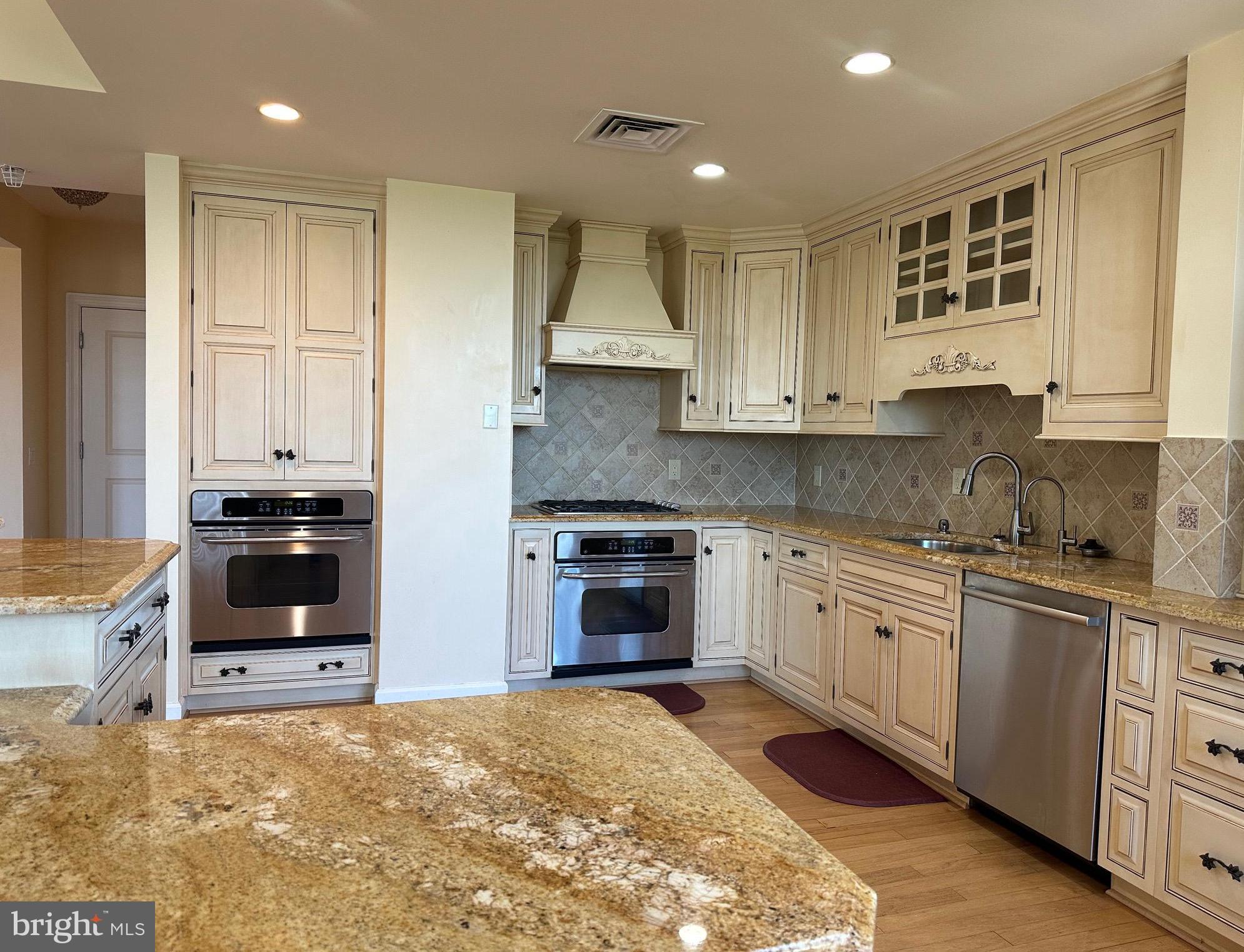 1830 Fountain Drive, Unit 607 Reston, VA 20190 - Photo 11 of 26 a kitchen with granite countertop a stove a sink and a refrigerator