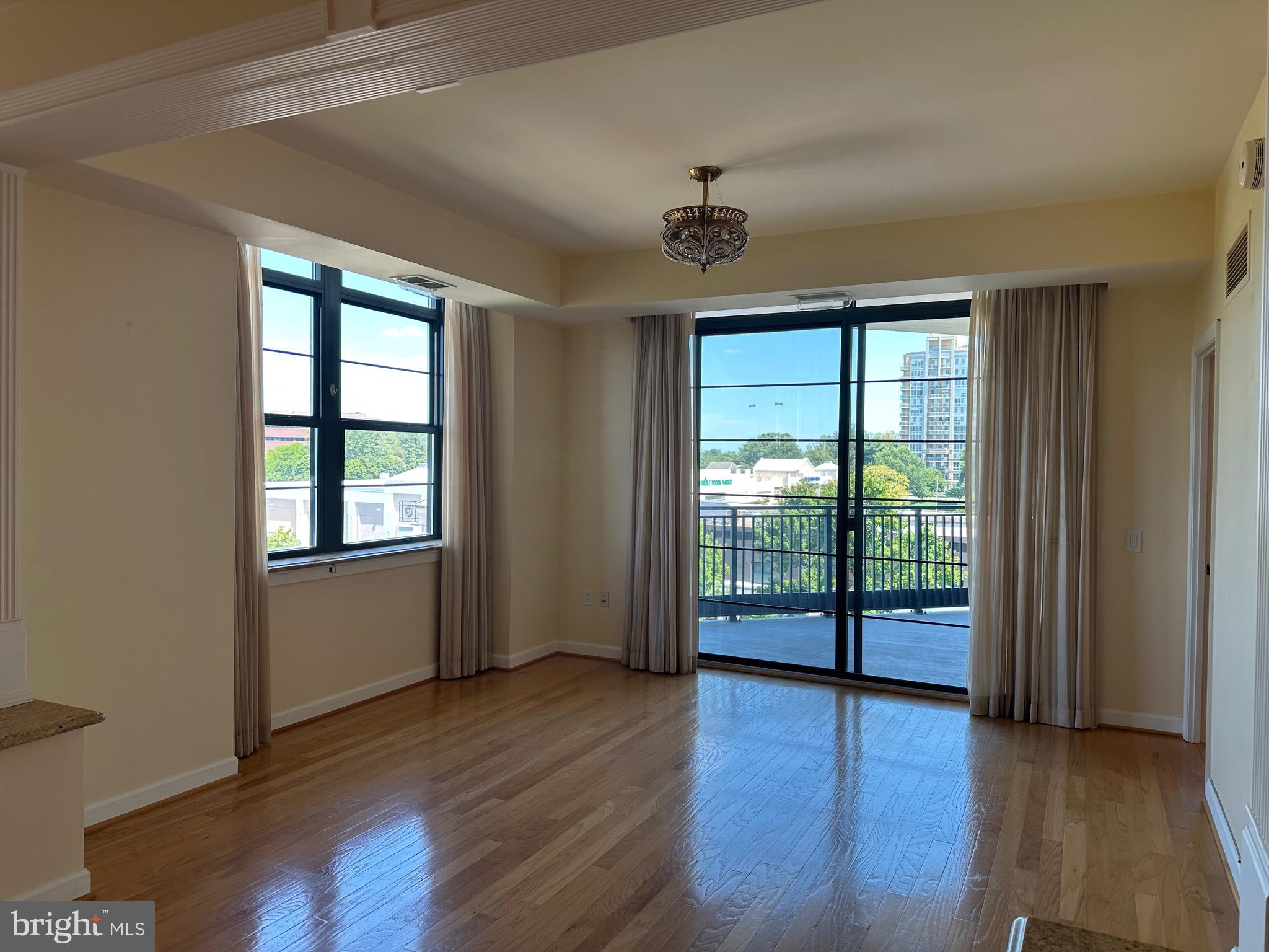 1830 Fountain Drive, Unit 607 Reston, VA 20190 - Photo 13 of 26 wooden floor in an empty room with a window