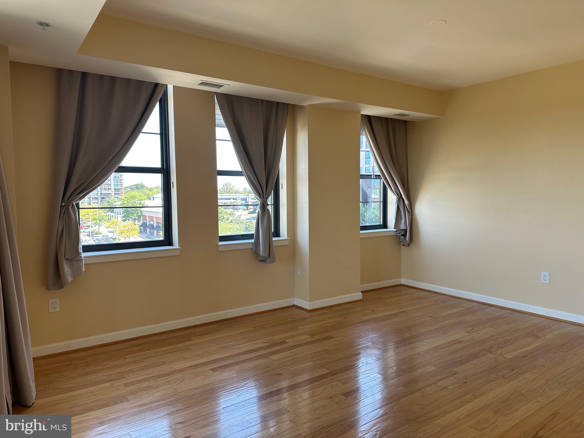 1830 Fountain Drive, Unit 607 Reston, VA 20190 - Photo 14 of 26 a view of an empty room with wooden floor and fan