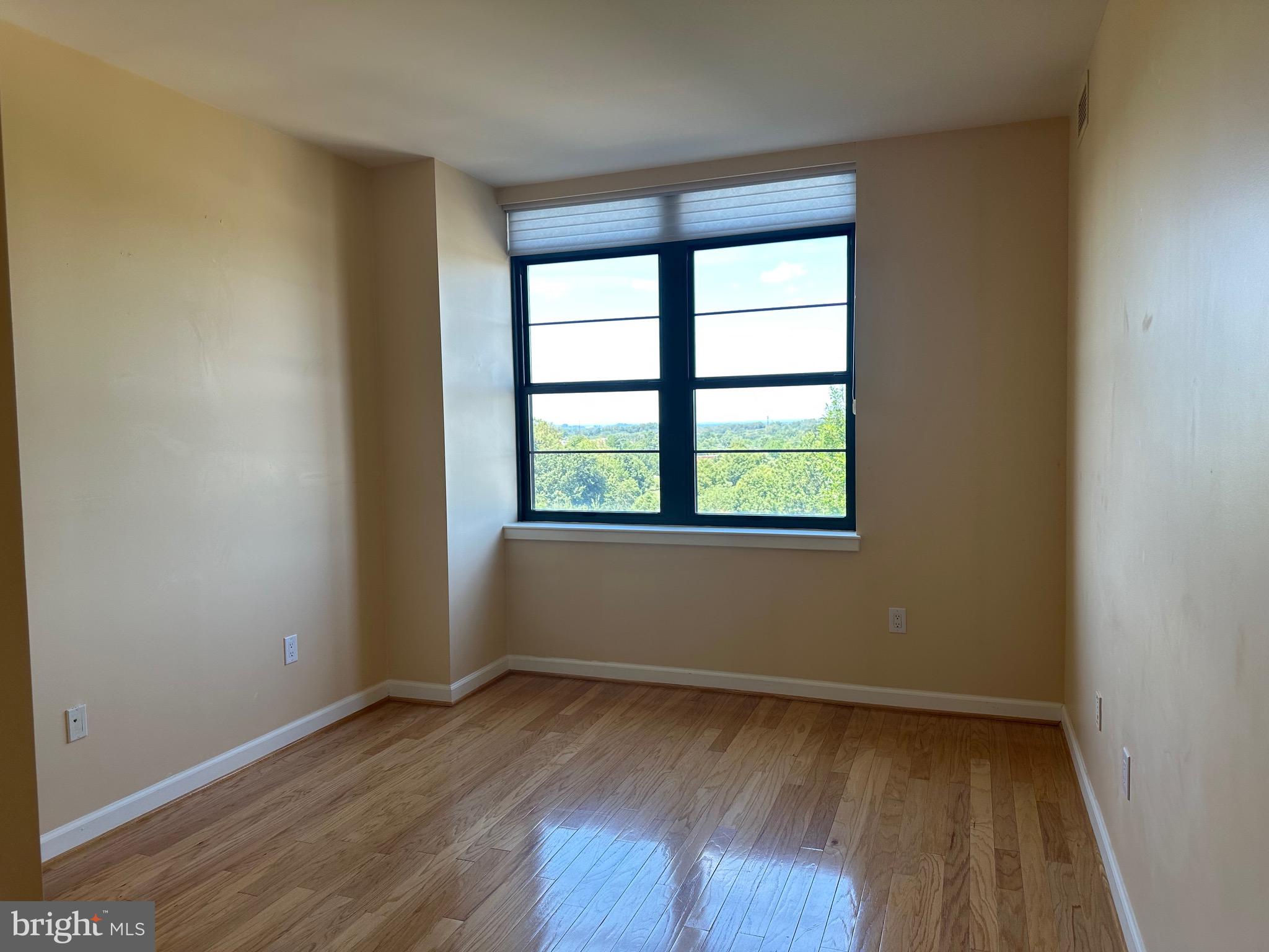 1830 Fountain Drive, Unit 607 Reston, VA 20190 - Photo 17 of 26 wooden floor in an empty room with a window