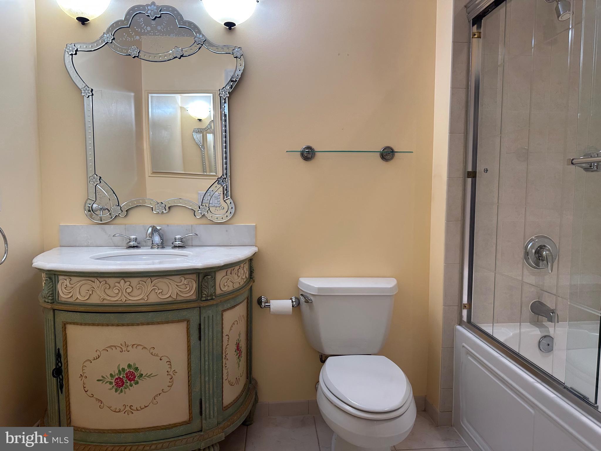 1830 Fountain Drive, Unit 607 Reston, VA 20190 - Photo 18 of 26 a bathroom with a toilet a sink and mirror