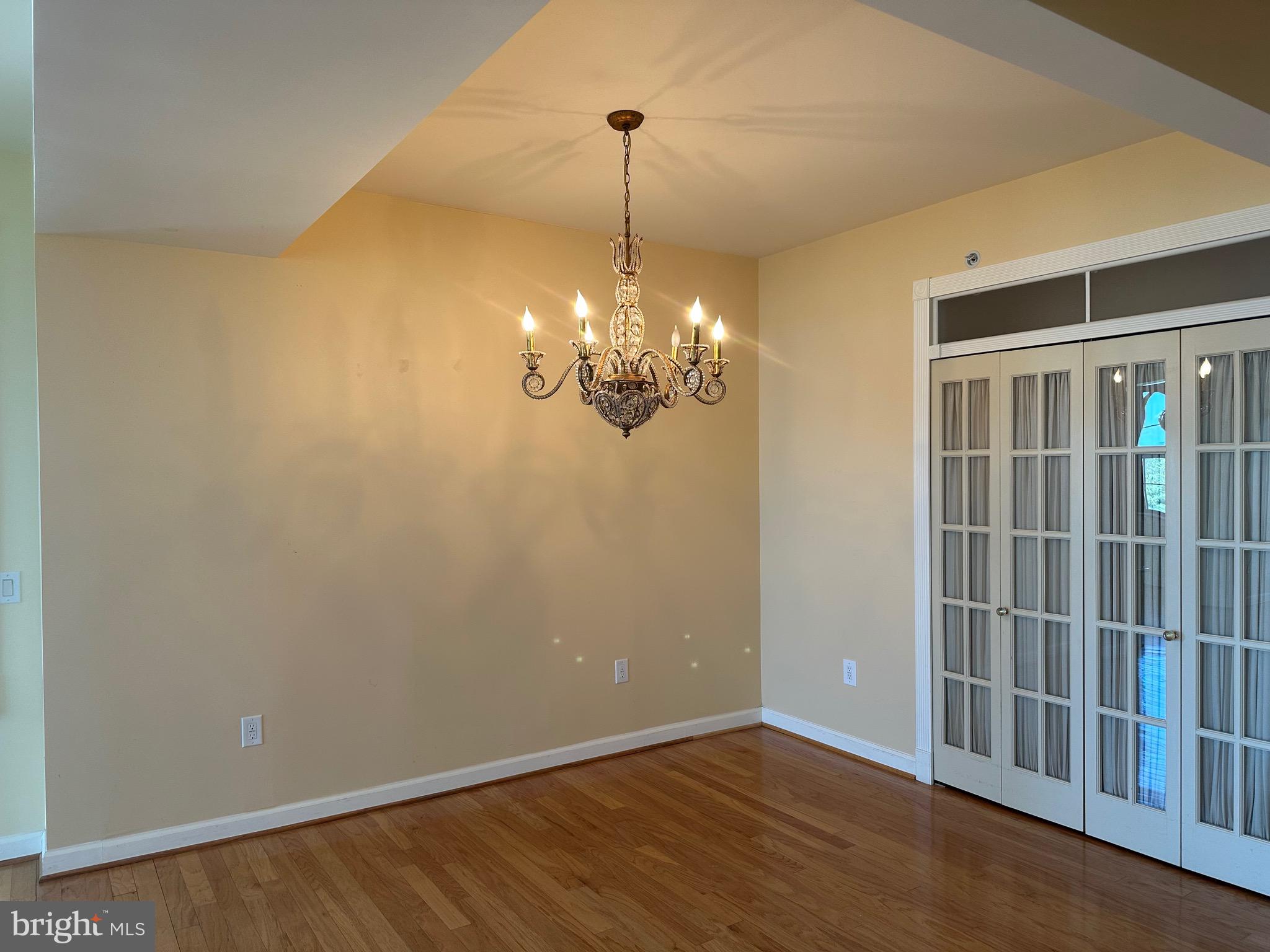 1830 Fountain Drive, Unit 607 Reston, VA 20190 - Photo 7 of 26 a view of a room with wooden floor and chandelier