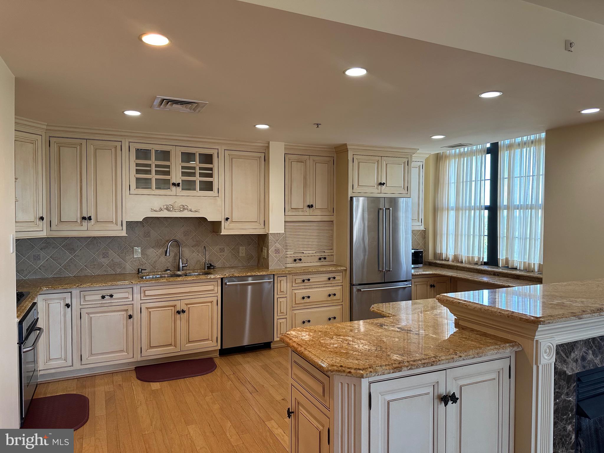 1830 Fountain Drive, Unit 607 Reston, VA 20190 - Photo 8 of 26 a kitchen with stainless steel appliances granite countertop a sink stove and refrigerator