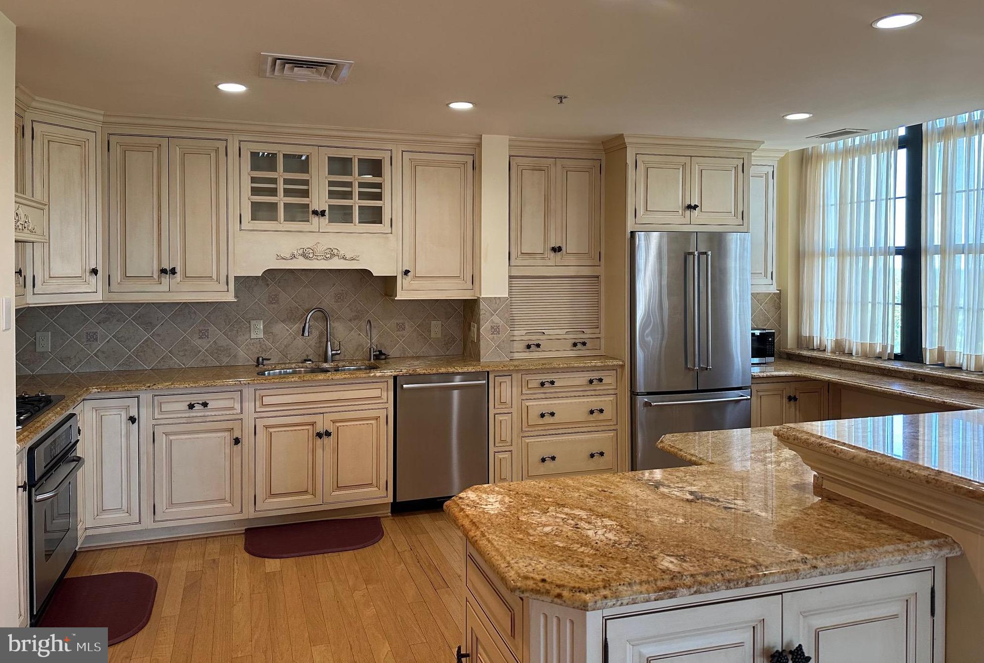 1830 Fountain Drive, Unit 607 Reston, VA 20190 - Photo 10 of 26 a kitchen with granite countertop a refrigerator and a sink