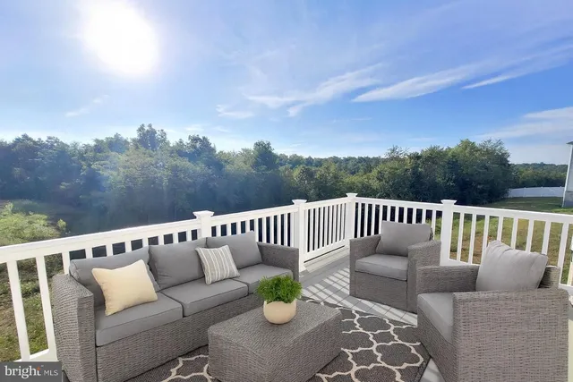 a balcony with wooden floor and breakfast area
