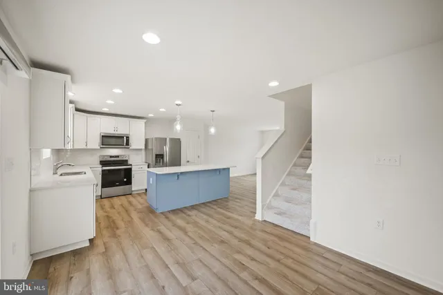 a view of kitchen with cabinets and wooden floor