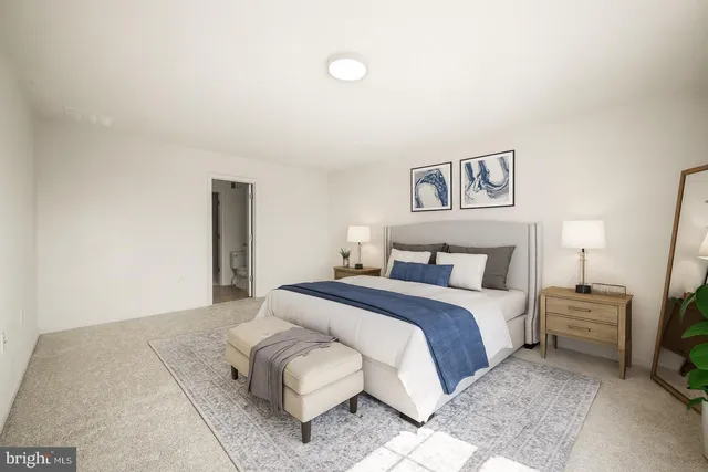 a bedroom with a bed and a night stand