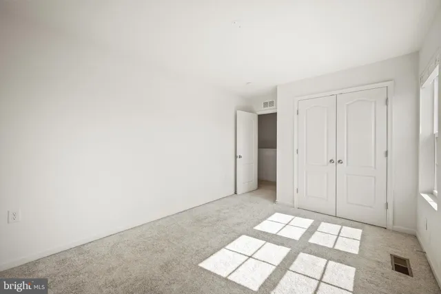 a view of livingroom with an empty space and window