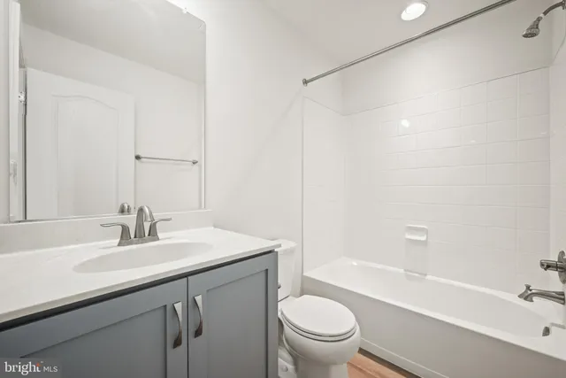 a bathroom with a sink toilet vanity and shower