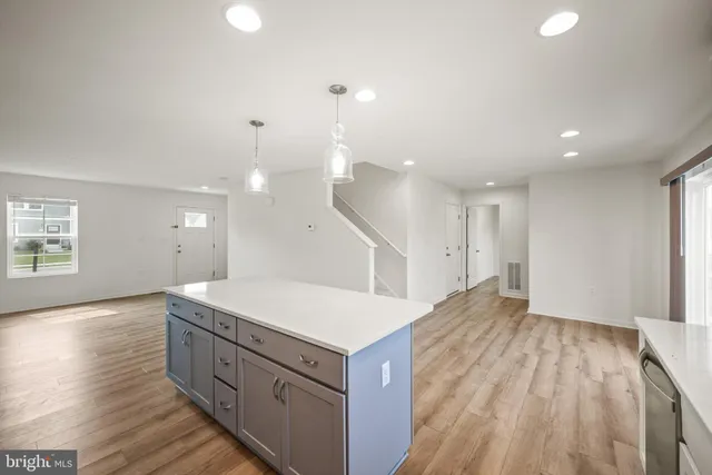 a kitchen with a sink a refrigerator and a window