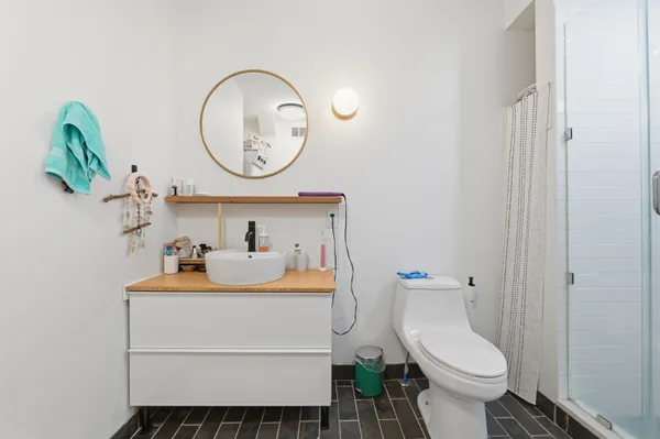 a bathroom with a sink toilet and a mirror