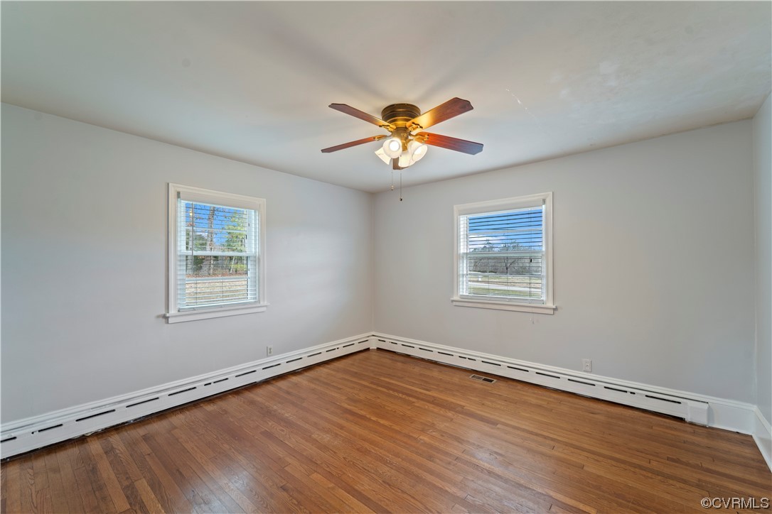 3600 Gregory Pond Road Chesterfield, VA 23236 - Photo 15 of 36 a view of a room with a wooden floor and a ceiling fan