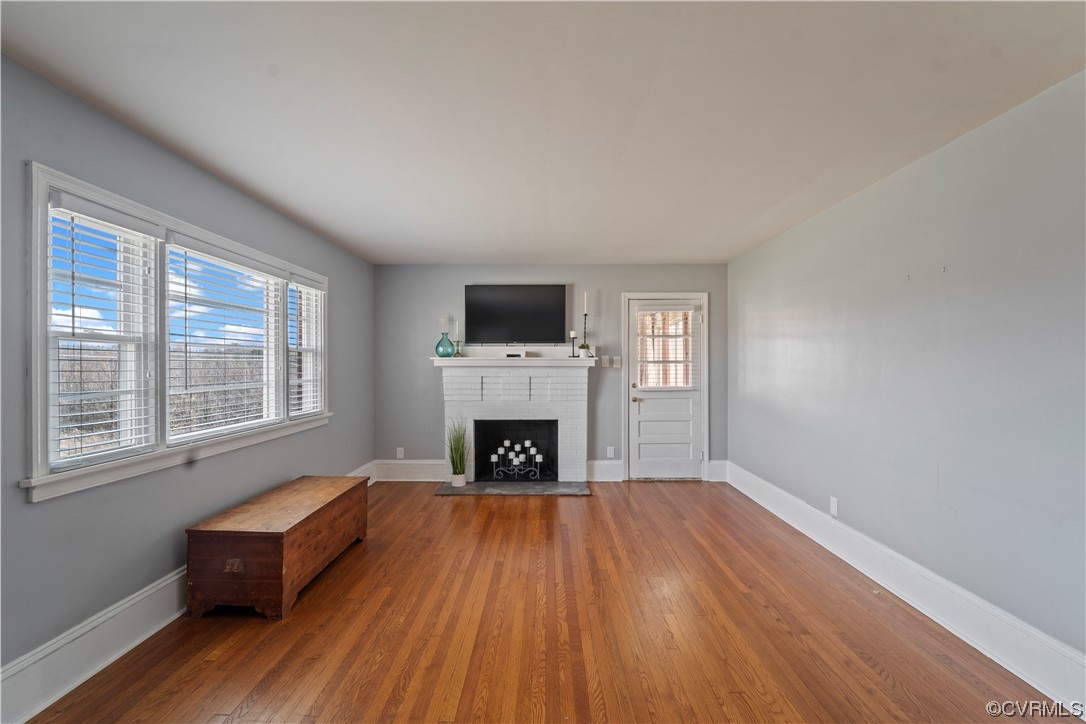 3600 Gregory Pond Road Chesterfield, VA 23236 - Photo 3 of 36 an empty room with fireplace wooden floor and windows