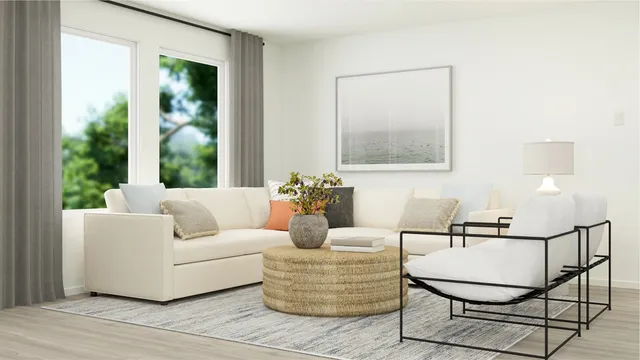 a living room with furniture and a potted plant