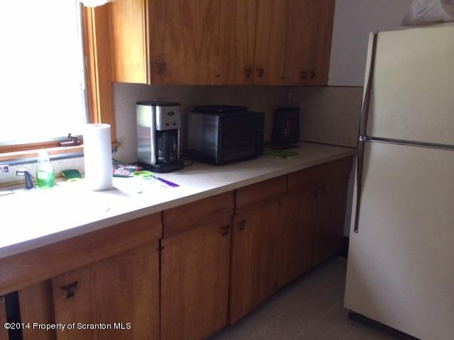 406 North State Street Clarks Summit, PA 18411 - Photo 4 of 6 a kitchen with stainless steel appliances a refrigerator and cabinets