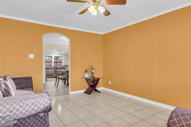 a view of a livingroom with furniture and chandelier fan