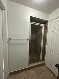 a bathroom with a glass door shower