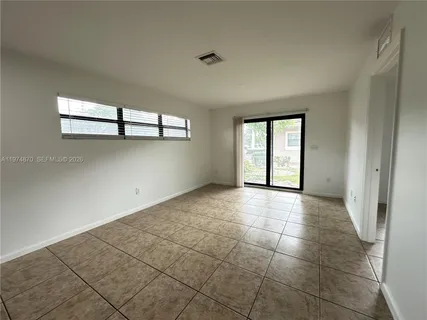 a view of an empty room with a window