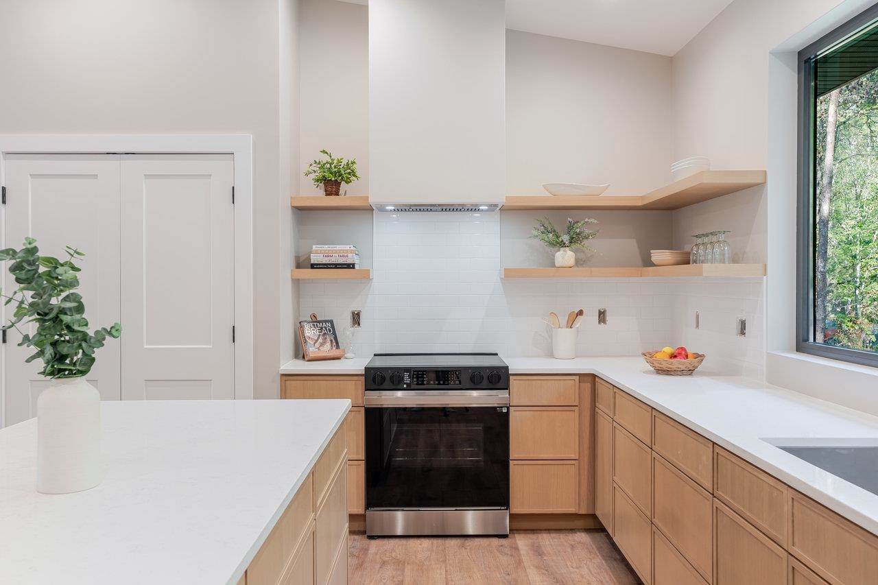 209 Beaver Road Basye, VA 22842 - Photo 11 of 68 a kitchen with stainless steel appliances a stove a white cabinets and a potted plant