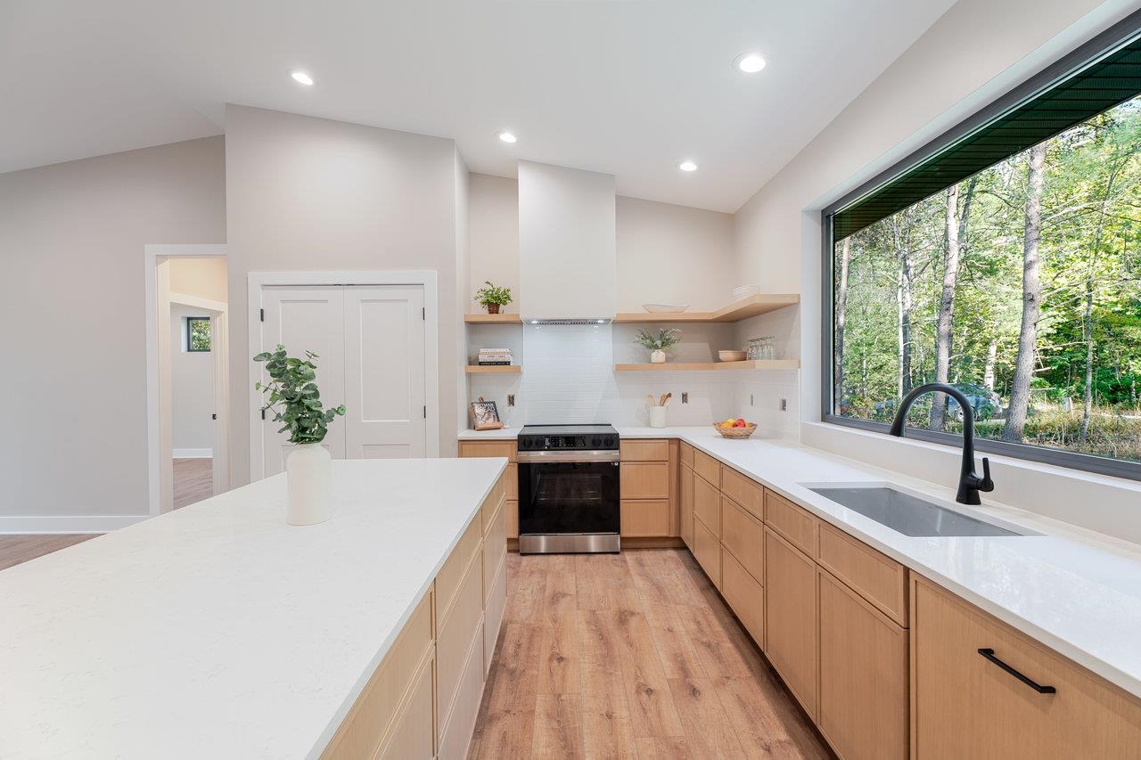 209 Beaver Road Basye, VA 22842 - Photo 12 of 68 a large kitchen with kitchen island white cabinets and stainless steel appliances