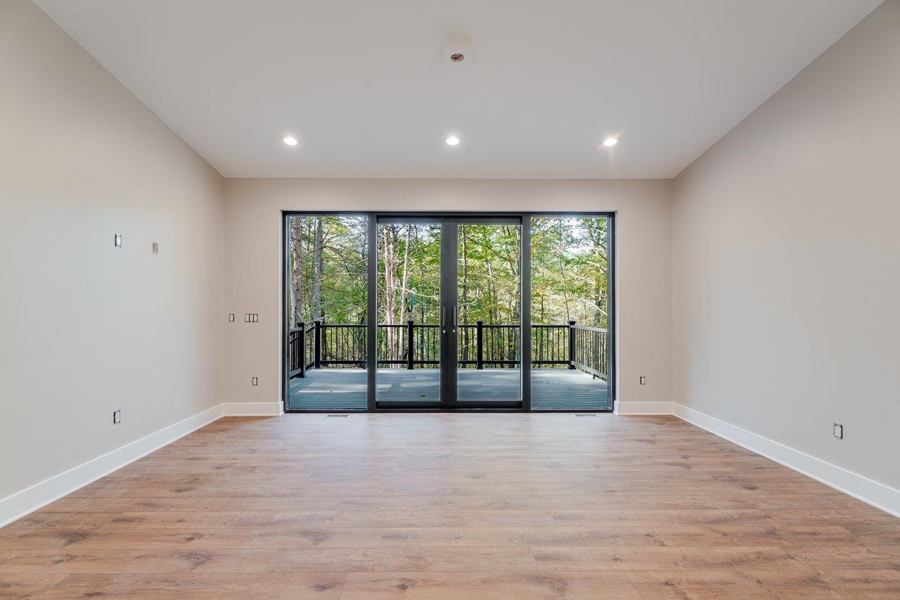 209 Beaver Road Basye, VA 22842 - Photo 18 of 68 a view of an empty room with wooden floor and a window