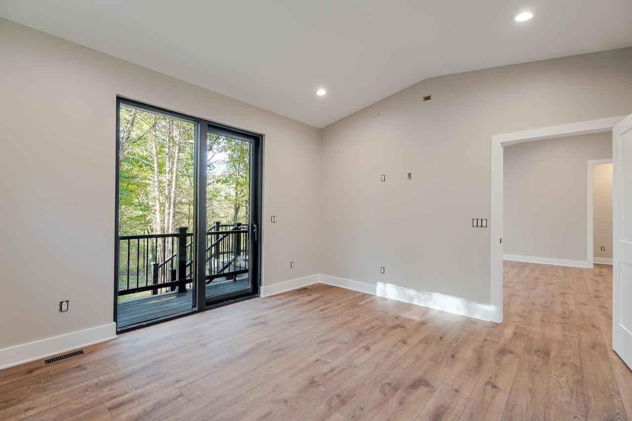 209 Beaver Road Basye, VA 22842 - Photo 25 of 68 a view of an empty room with wooden floor and a window