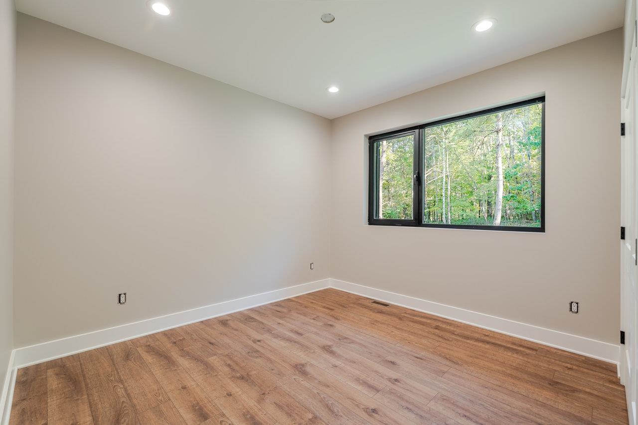 209 Beaver Road Basye, VA 22842 - Photo 29 of 68 a view of an empty room with wooden floor and a window
